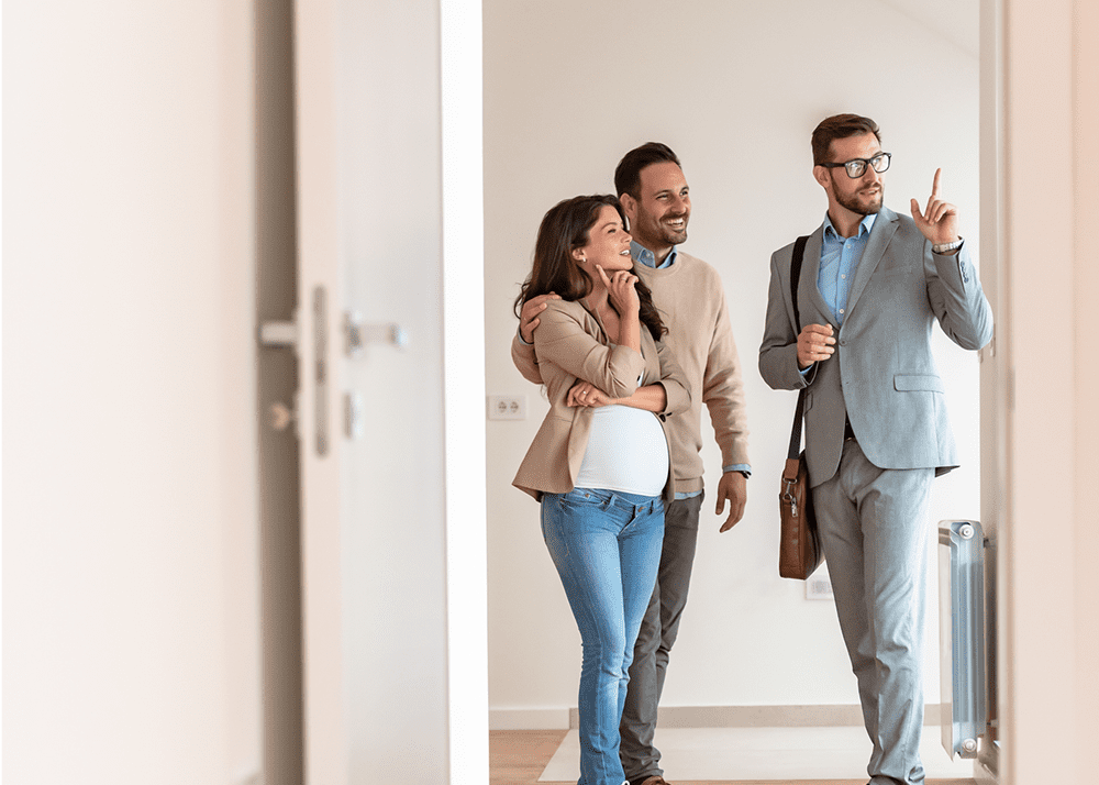 Couple touring home with real estate agent